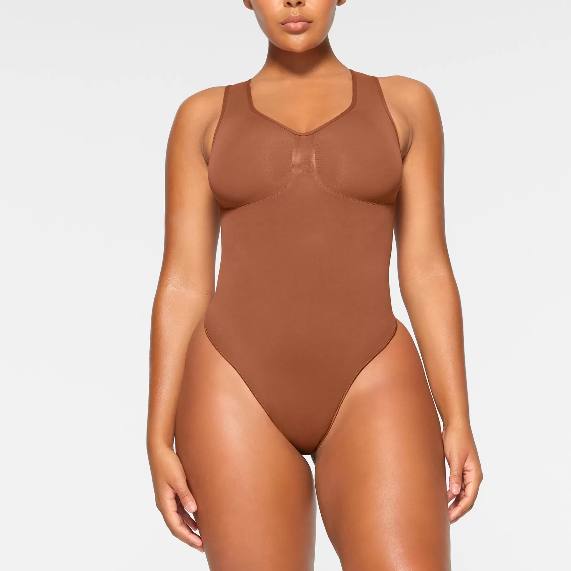 Skims seamless sculpt*SEAMLESS SCULPT SCOOP NECK THONG BODYSUIT | BRONZE